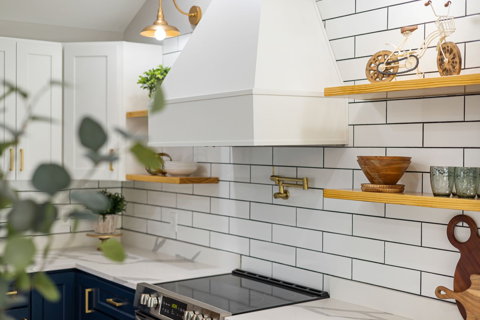 White subway tile backsplash with brass fixtures
